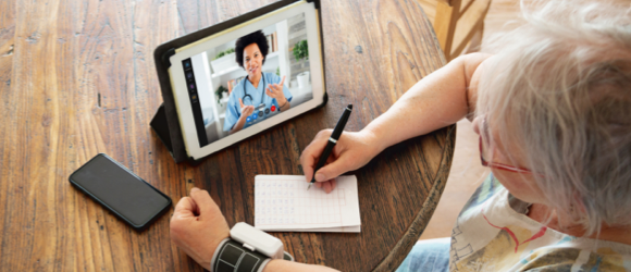 patient wearing device, on her laptop talking to a provider