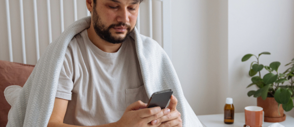 sick male patient talking to provider on the phone